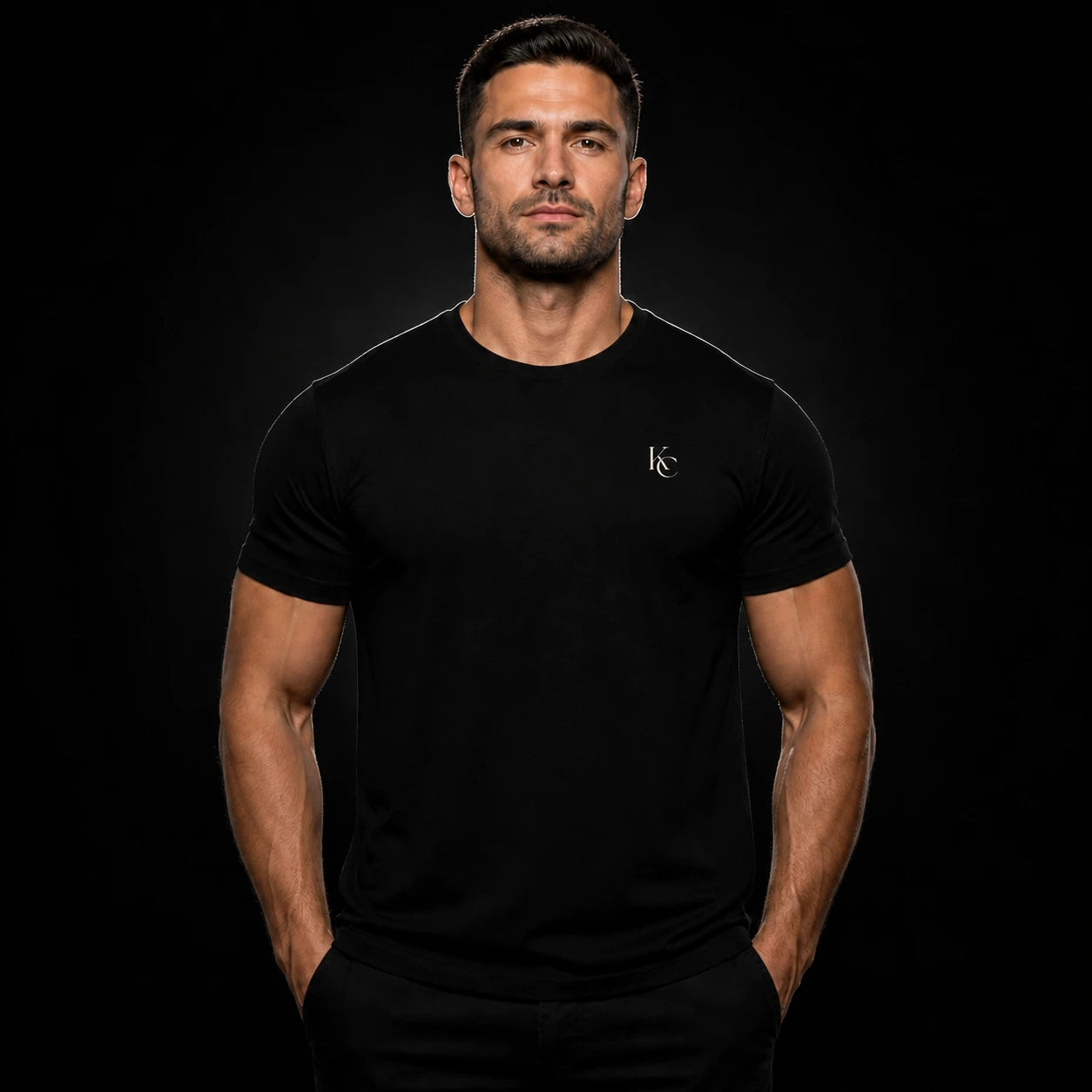 Muscular male model wearing the black T-shirt with KC left-chest logo #color_black